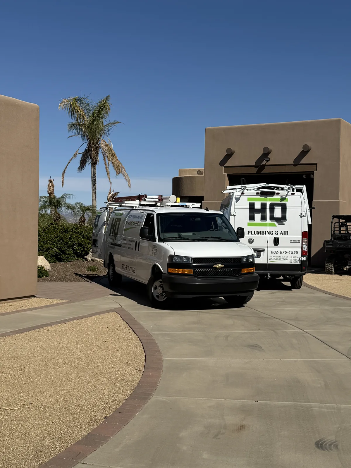 HQ Plumbing van parked in the driveway of a Phoenix hillside home on a residential service call