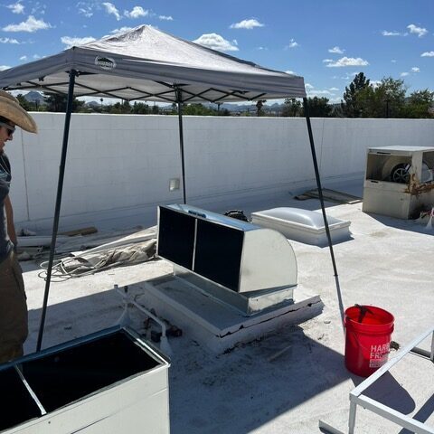 Commercial Air Conditioning Roof installation with equipment and tent.